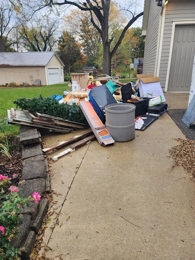 Dumpster being loaded with debris for 12 Yard Dumpster Rental in Claiborne